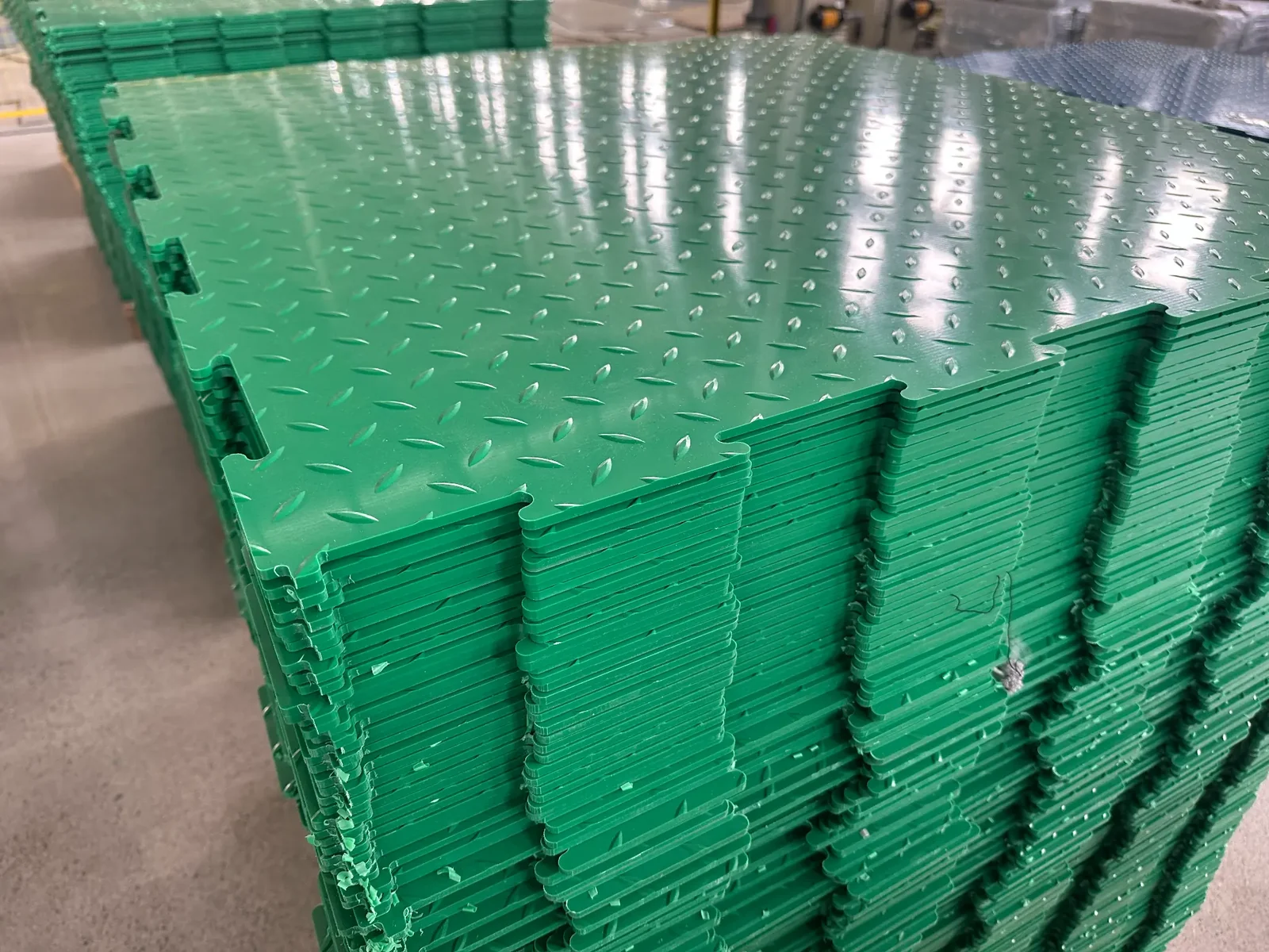Company-supplied factory photo: green interlocking-edge detail.